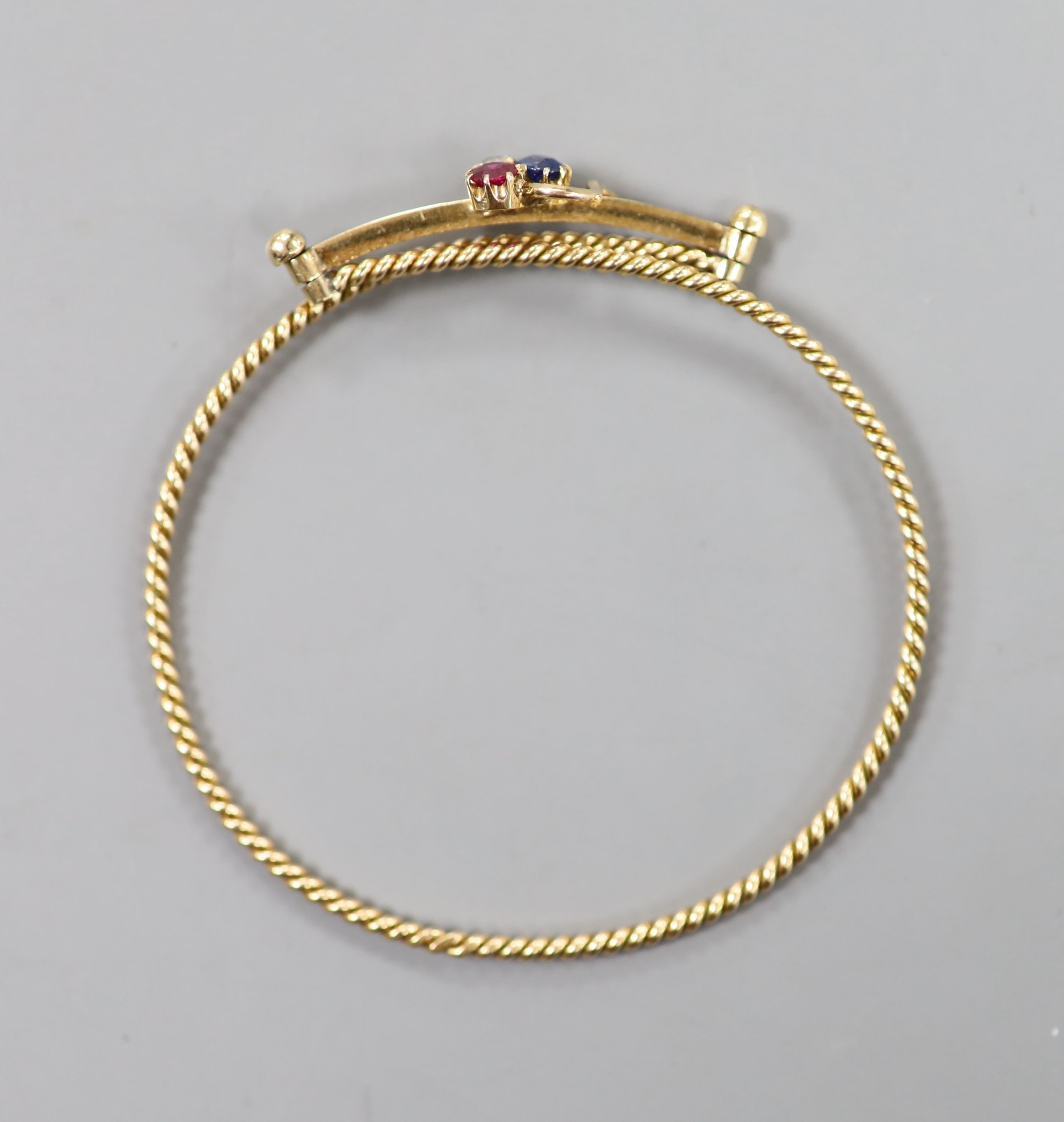 An early 20th century Russian 56 zolotnik yellow metal, ruby, sapphire and diamond 'clover' set articulated bangle